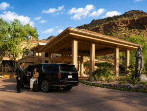 Executive transportation service in Phoenix and Scottsdale with chauffeur assisting a business traveler from a luxury SUV at a Scottsdale resort